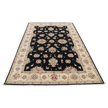 beige rug with black pattern, beige rug with blue accents, beige rug with blue border